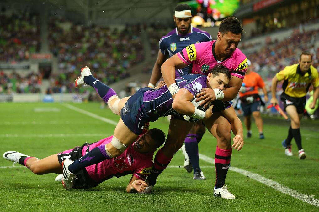 MELBOURNE, AUSTRALIA - MARCH 15: Billy Slater of the Storm is tackled by Elijah Taylor of the Panthers during the round two NRL match between the Melbourne Storm and the Penrith Panthers at AAMI Park on March 15, 2014 in Melbourne, Australia. (Photo by Michael Dodge/Getty Images)