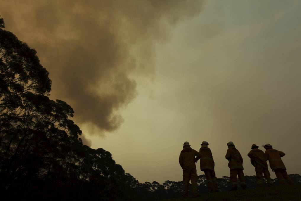 NSW RFS Crews watch the fire front approaching Bilpin behind properties north of the Bells Line of Road. Photo: Wolter Peeters 21st October 2013 The Sydney Morning Herald photo.JPG