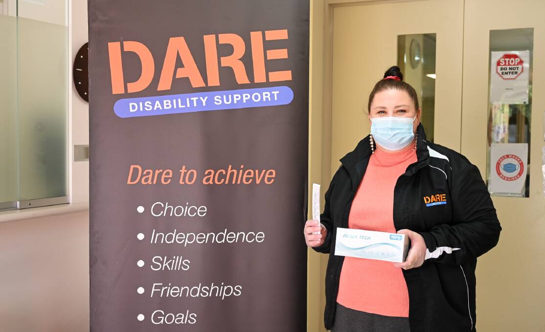 Testing times: DARE Disability Support senior client service co-ordinator Emma Coghlan with a rapid antigen testing kit. 