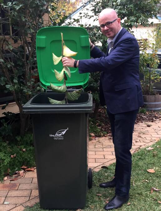 Branching out: Blue Mountains mayor Mark Greenhill makes good use of a green bin. 