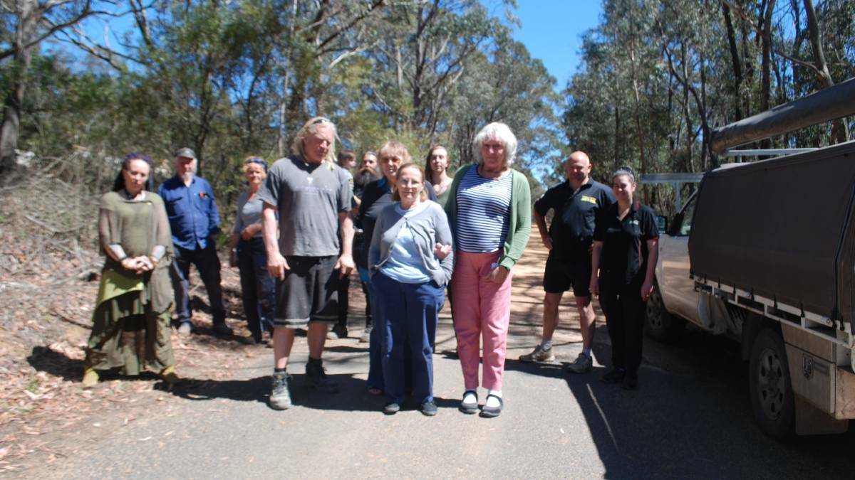 Concerned residents: Sean Butler, Kaye Whitbread, Hope Fletcher and Nicola Madden (front) and fellow residents on Sandham Road, Bell. Newnes Junction village is located in Lithgow council area, but the site can only be accessed by using Sandham Road from Bell to the quarry. 