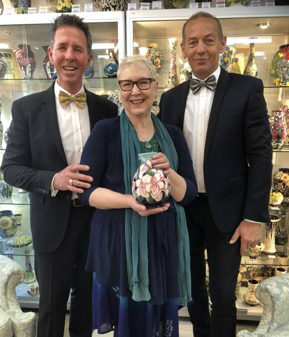 FINE ART: Kevin (left) and Garry Austin of Faulconbridge Antiques with Blue Mountains Rhododendron Society president Deborah Wells and the rhododendron vase.