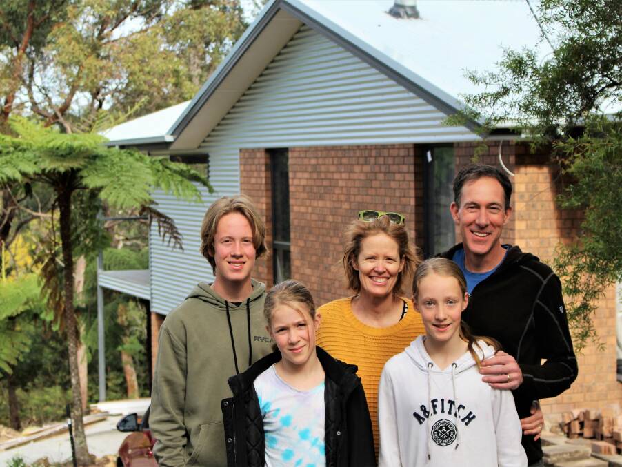 JUST GO: Springwood resident Chris Mein with his family. He found the Bushfire Building Community Day invaluable when preparing to renovate his home.