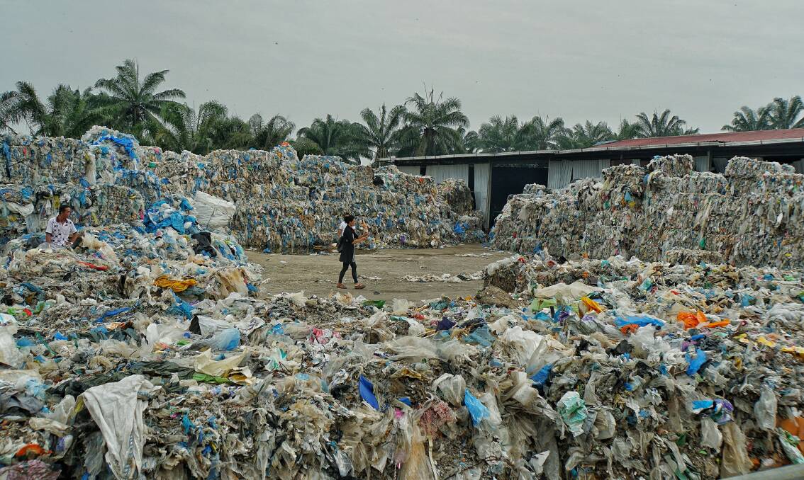 Plastic Piles: Imported plastic waste at a closed down, illegal recycling factory in Malaysia. 