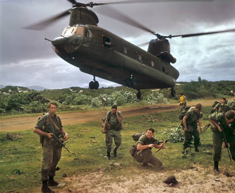 At War: Australian troops in South Vietnam in 1967. The US Chinook helicopter lifted the soldiers to a fishing village to search for Viet Cong activity. Picture: Michael Coleridge 
