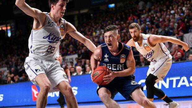 Nelson Larkins of the Adelaide 36ers breaks past Dane Pineau and Adam Thoseby at Titanium Security Arena in Adelaide. Photo: AAP