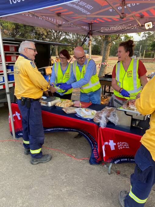 Helping out: Labor politicians Susan Templeman, Mark Greenhill and Trish Doyle serving breakfast during a shift changeover at Katoomba staging ground on December 31 2019. Photo taken by RFS crew member.