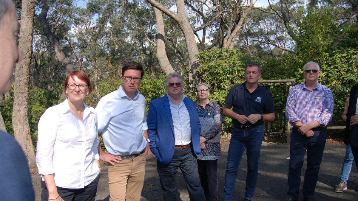 Macquarie MP Susan Templeman, the Minister for Natural Disaster and Emergency Management David Littleproud, chairman of Blue Mountains Economic Enterprise Donald Luscombe, president of Blackheath Rhododendron Society Deb Wells, head of the National Bushfire Recovery Agency Andrew Colvin and Mark Barton from the Blue Mountains Regional Business Chamber at the Campbell Rhododendron Gardens earlier this evening (Monday).