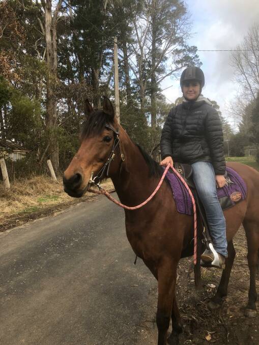 Maddie Lemonjian riding her bay mare Milly along Jubilee Street, North Katoomba.