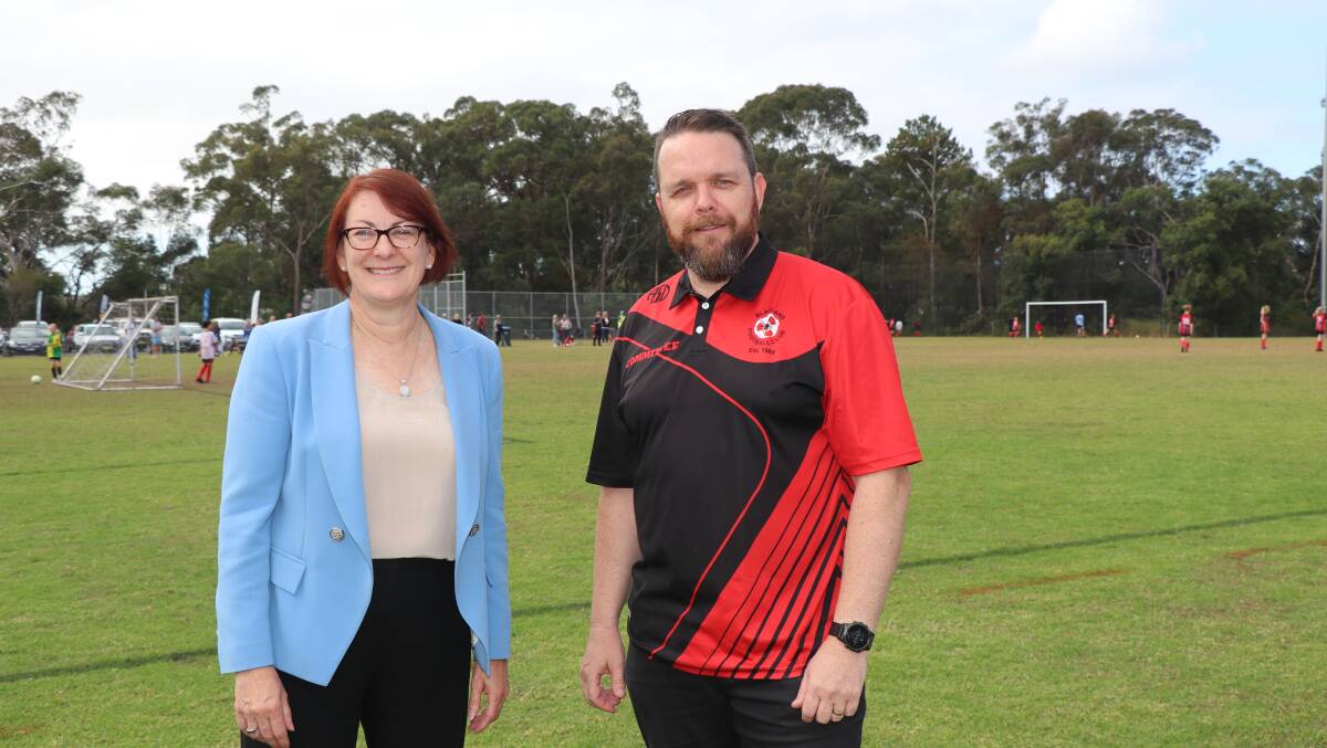 Federal Member for Macquarie Susan Templeman and Blaxland Football Club President Steve Myhill with the new fence and goal posts on the training field in the background.