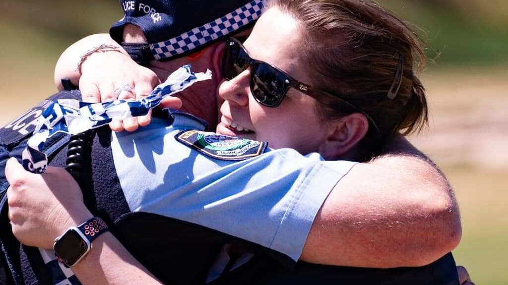 Sergeant Cynthia Walder (right) hugs a fellow officer who took part in the fundraising ride/run last year. Picture supplied