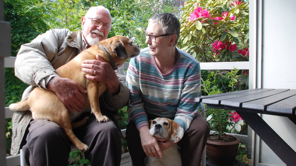 Back home: Tony Morgan holding Mimi and Deb Wells with Snoopy after their big adventure.