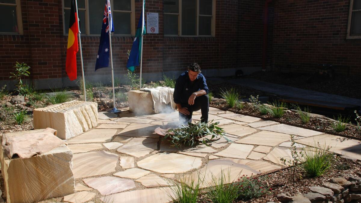 Paul Glass starting the smoking ceremony in the Indigenous healing garden at Katoomba Hospital.