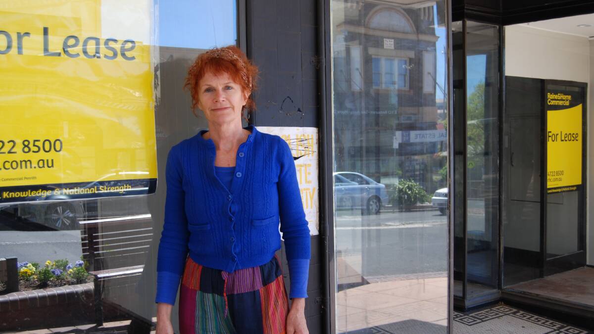 Cr Kerry Brown: In front of two of the empty shops near the entrance to town.
