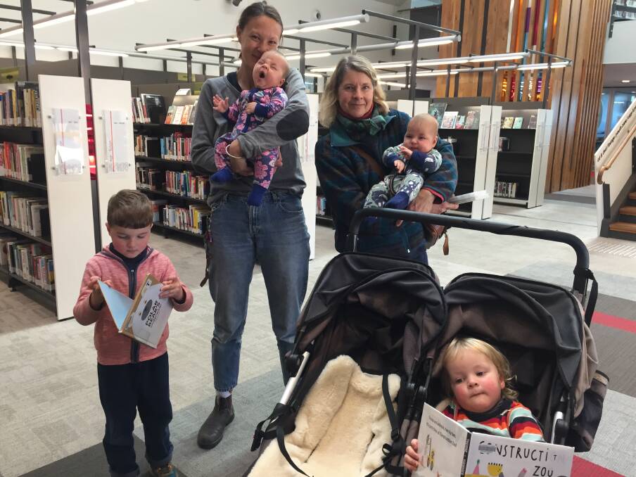 New reading: Steph Tsai, holding Blossom, mother-in-law Ellen Webb, holding Blossom's twin, Goldie (five months old) with Hank (4) and Ches (2) in Katoomba library.