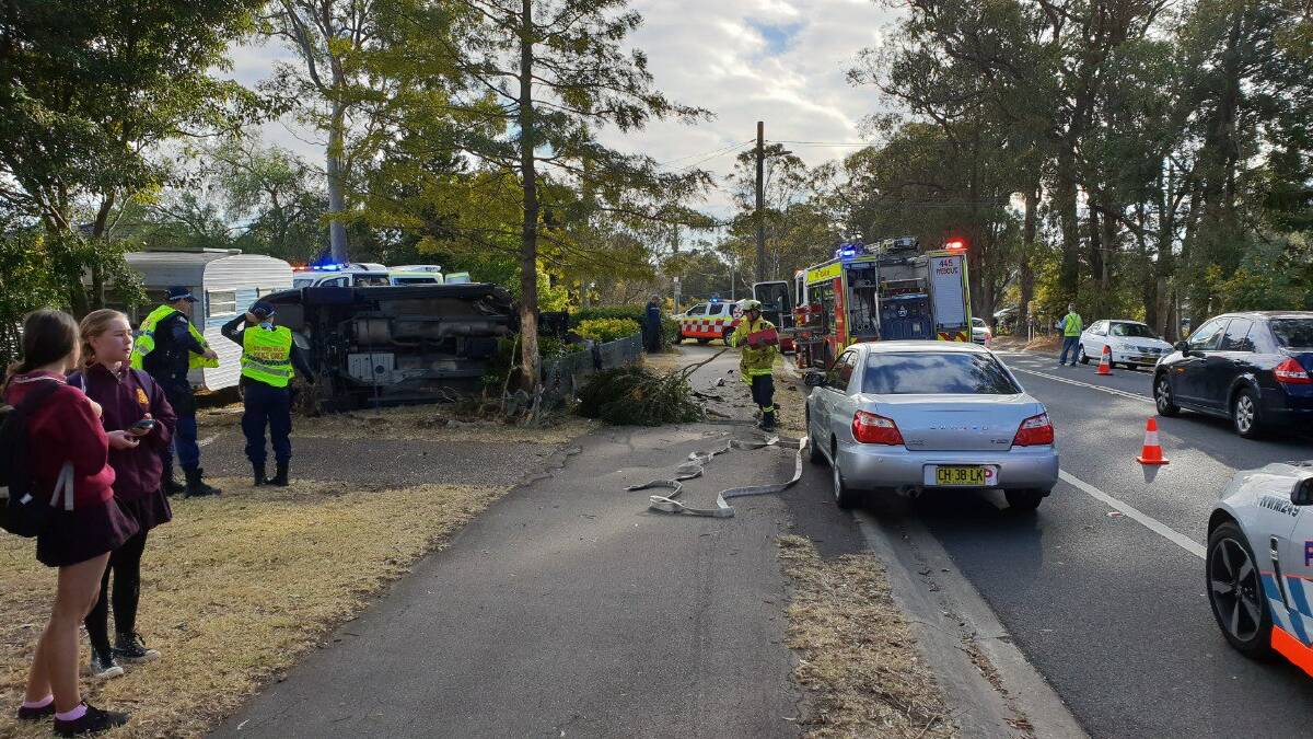 Overturned: Emergency workers at the scene of the accident on Hawkesbury Road, Winmalee, on Monday morning. Photo: Top Notch Video