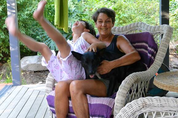 Sally Tracy AM with granddaughter Charlie and dog Pip on the verandah of her Glenbrook home. Pictures supplied