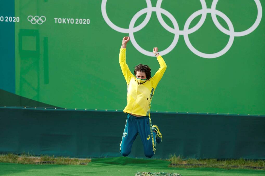 Jumping for joy: Jessica Fox shows her excitement when called to the podium to accept her gold medal. Photo: AP 