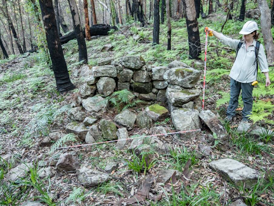 Fiona Leslie, principal heritage consultant with Mountains Heritage, takes some measurements in the old shale camp.