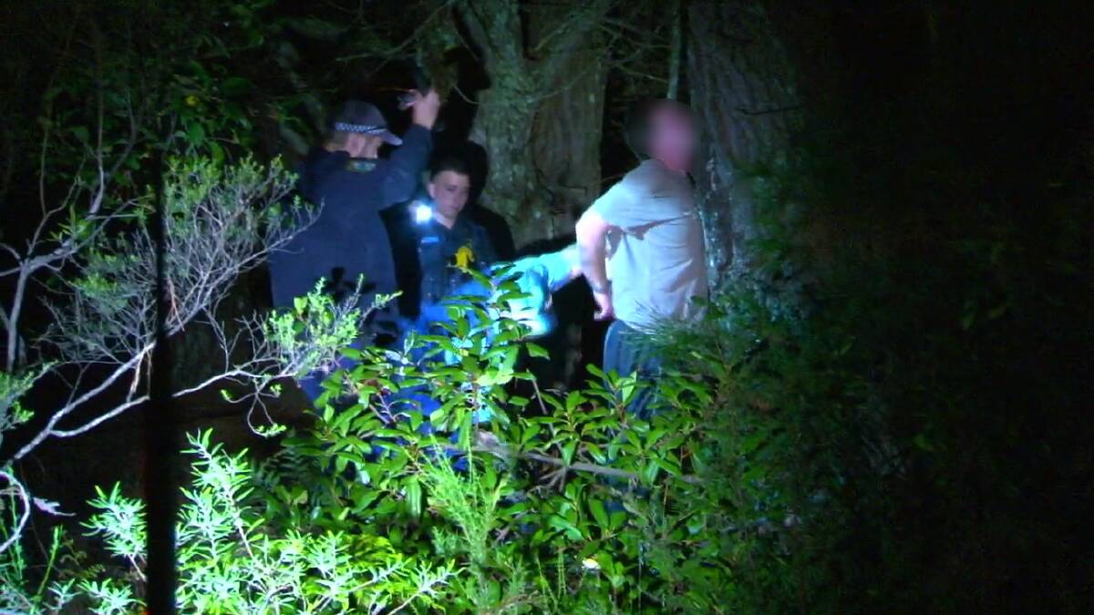 Taken into custody: Police with the alleged offender of a knife attack in Katoomba on Thursday evening. Photo: Top Notch Video