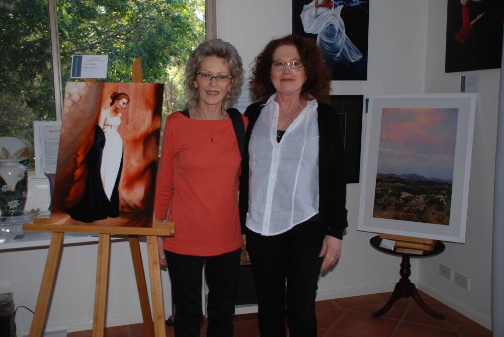 Gateway help: Gerlinde Thomas (beside her painting, Jacqueline) and Roslyn Elms, in front of her work, Finke Valley, in Elms' gallery in Faulconbridge. 