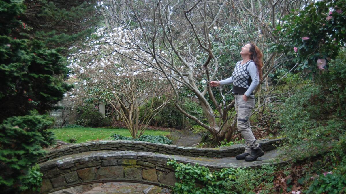 Ewanrigg: Jessica Lawn on the beautiful stone bridge in one of the four neighbouring gardens she maintains.