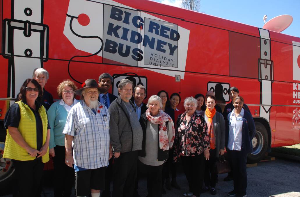 Front row, David Gleeson from Victoria (in hat) stands next to fellow patients Mario Ackermans (Katoomba) and Louise McLean (Foster) with the clinicians, technicians and carers from the Big Red Kidney Bus.