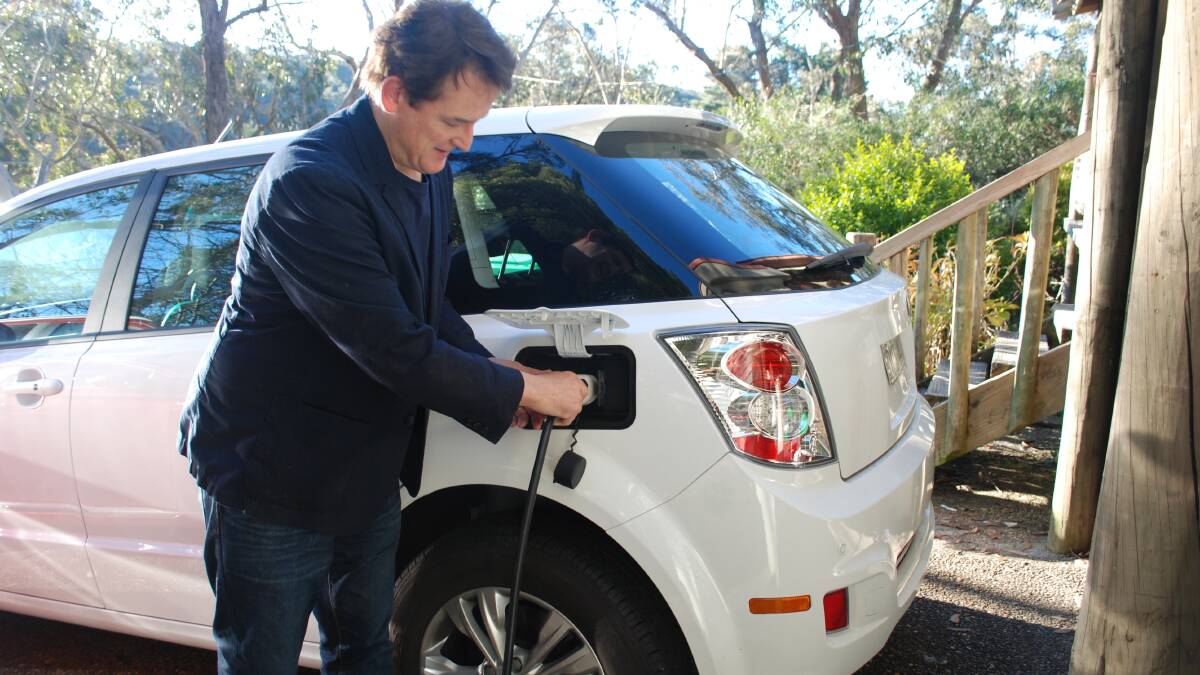 Plugged in: Jon Dee charging his BYD electric car, the only one of its kind in Australia. It can go up to 400 kilometres on a single charge.