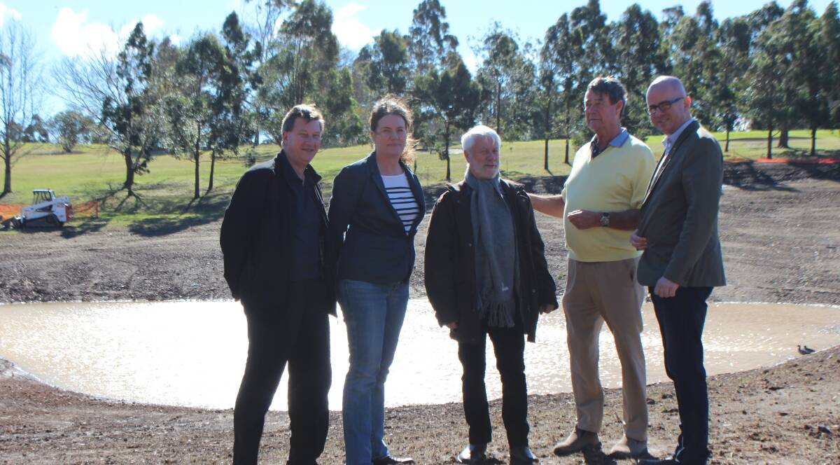 Fire help: Club general manager Michael Huff, Trish Doyle MP, Cr Mick Fell, club vice-president Philip French and Mayor Mark Greenhill inspect the new dam.