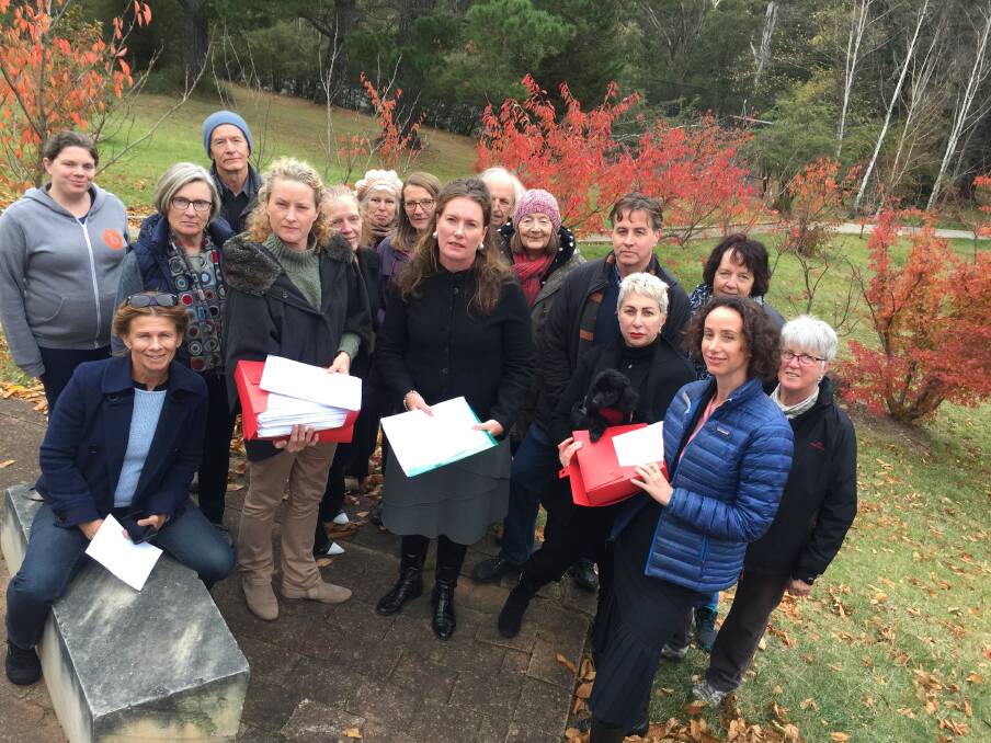 Sophie Sievers and Meredith Tucker from the Katoomba Airfield community group hold the folders of petitions presented to Trish Doyle, MP, at Medlow Bath.