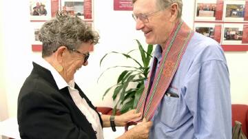 Mary Waterford gives Bendigo Bank's Peter Carroll a Tais, a traditional woven cloth in Timor-Leste, as thanks for the bank's sponsorship of a new documentary. Picture supplied