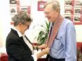 Mary Waterford gives Bendigo Bank's Peter Carroll a Tais, a traditional woven cloth in Timor-Leste, as thanks for the bank's sponsorship of a new documentary. Picture supplied