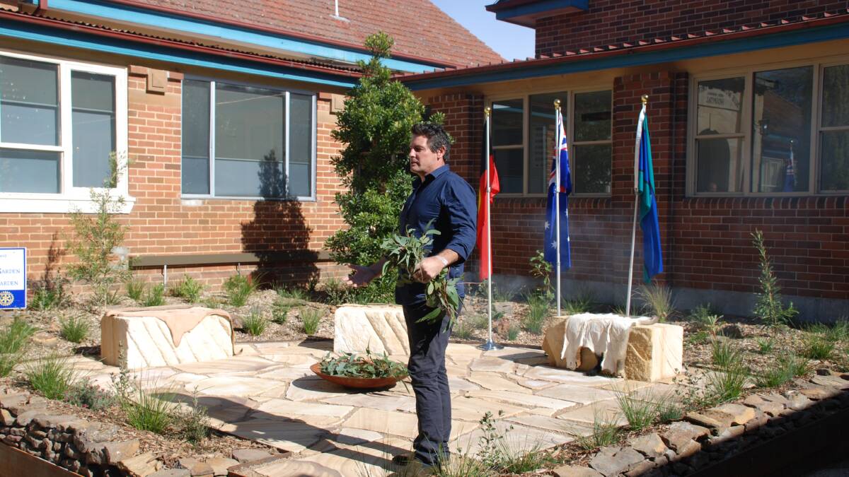 New garden: Paul Glass conducts a smoking ceremony in the fire pit of the new Indigenous healing garden at Katoomba Hospital.