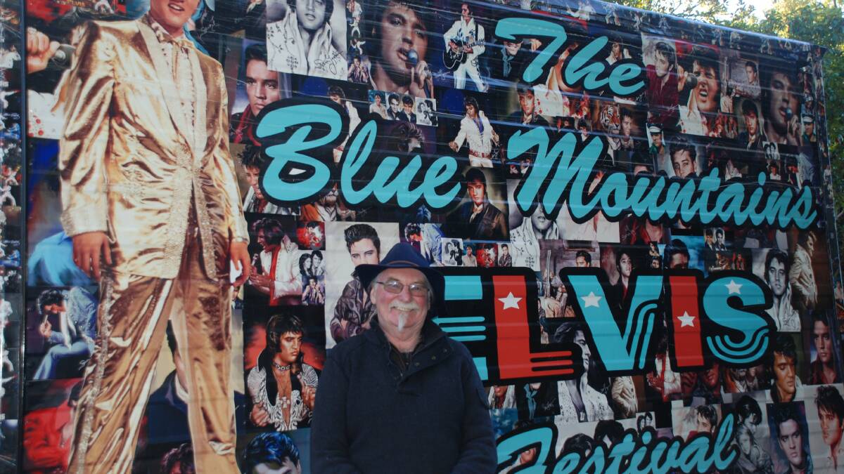 Elvis festival guru Colin Greene in front of one of the trucks he painted.
