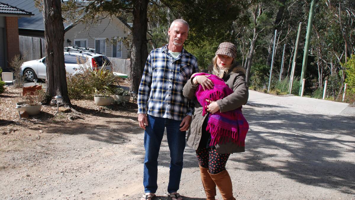 Residents Morten Storaker and Sally Stevens (with baby Stevie) on the unformed part of Rupert St North Katoomba.