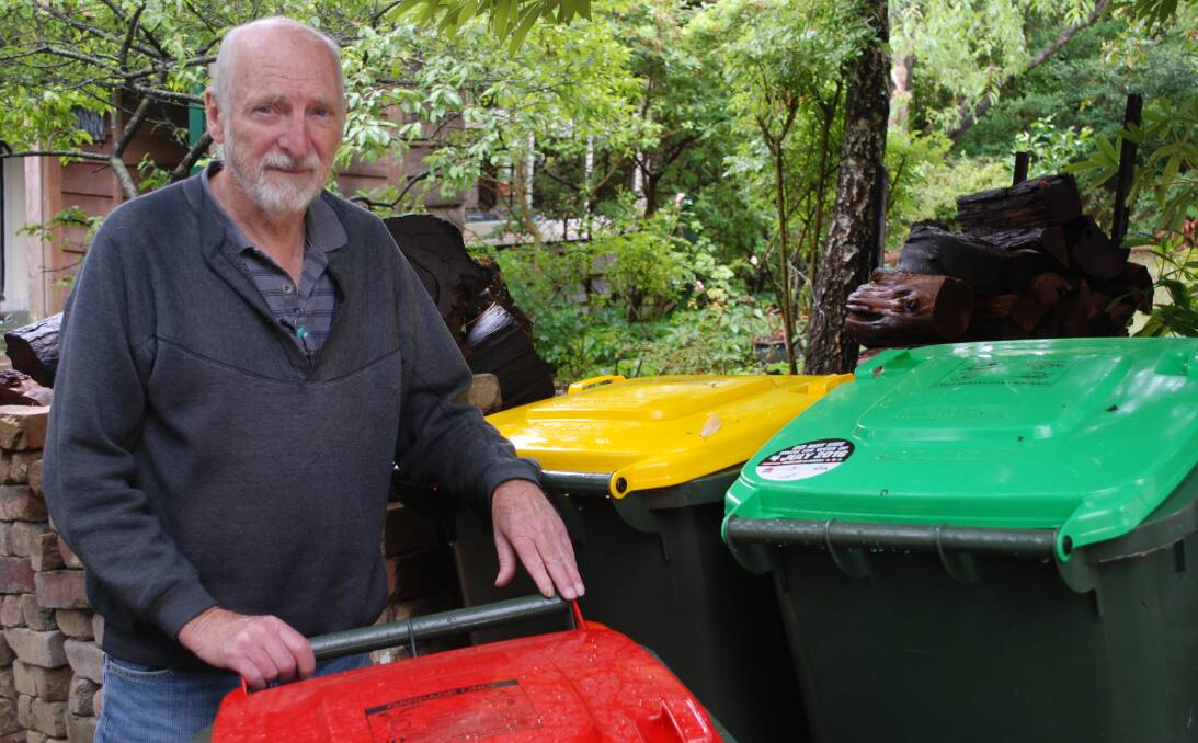Overcharged: John Mann with his garbage bins. The delivery of two green bins last year alerted him to the fact that he has been overcharged for his service for 20 years.