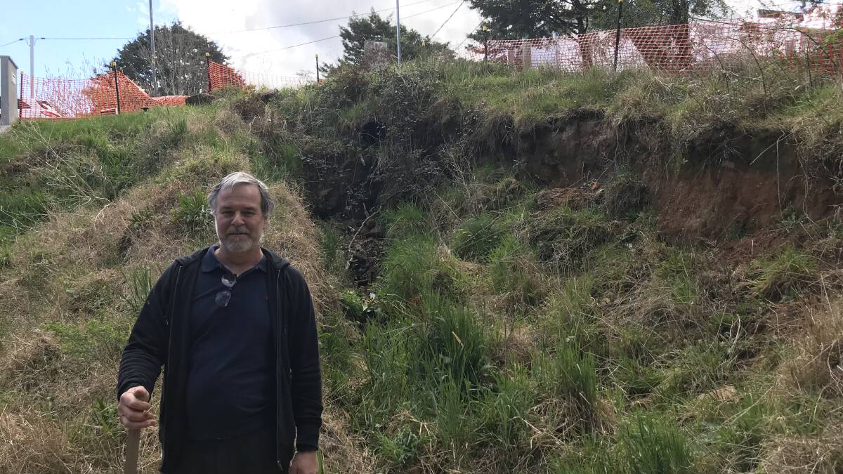 Landslip in South Katoomba: James Perkins in front of the eroded land adjoining his property.