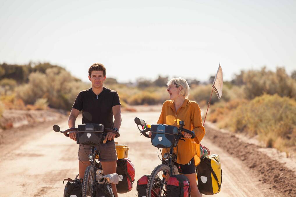 Pedal power: Owen Kelly and Bobbie Bayley at Dalhousie Springs in Western Australia. They cycled across Australia to study its architecture. Photo by Dillon Seitchik-Reardon