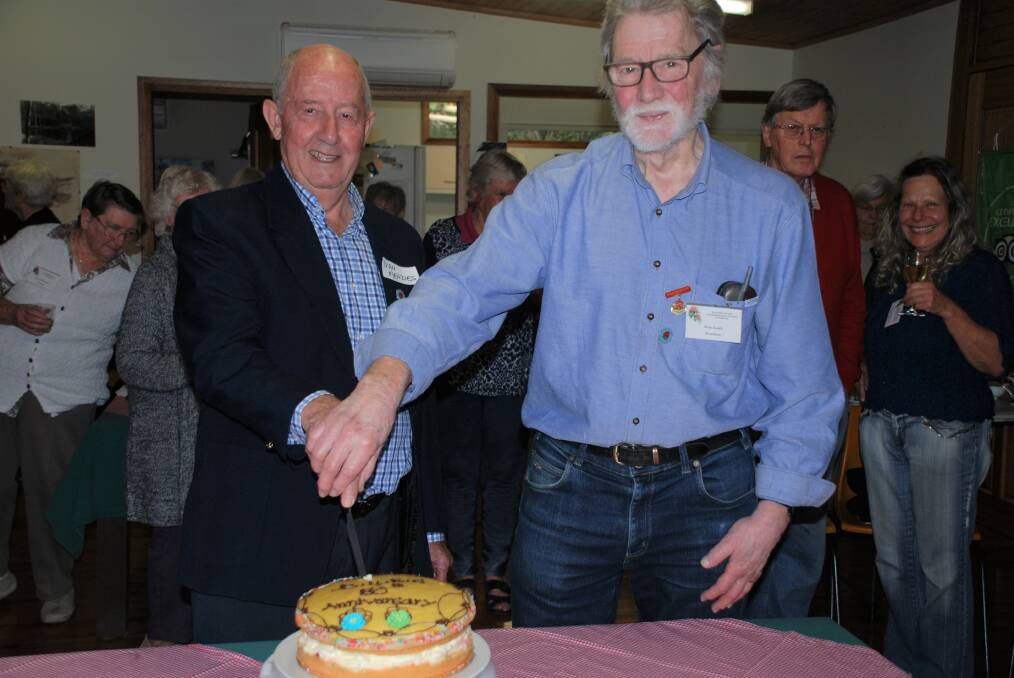 Celebration: Blue Mountains Rhododendron Society's 3rd president, Ivan Menzies, and  current president, Alan Lush, cut the cake.