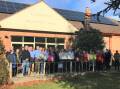 Blackheathens and Bendigo Bank board members celebrate the 98 solar panels on the roof of the town's community hall.