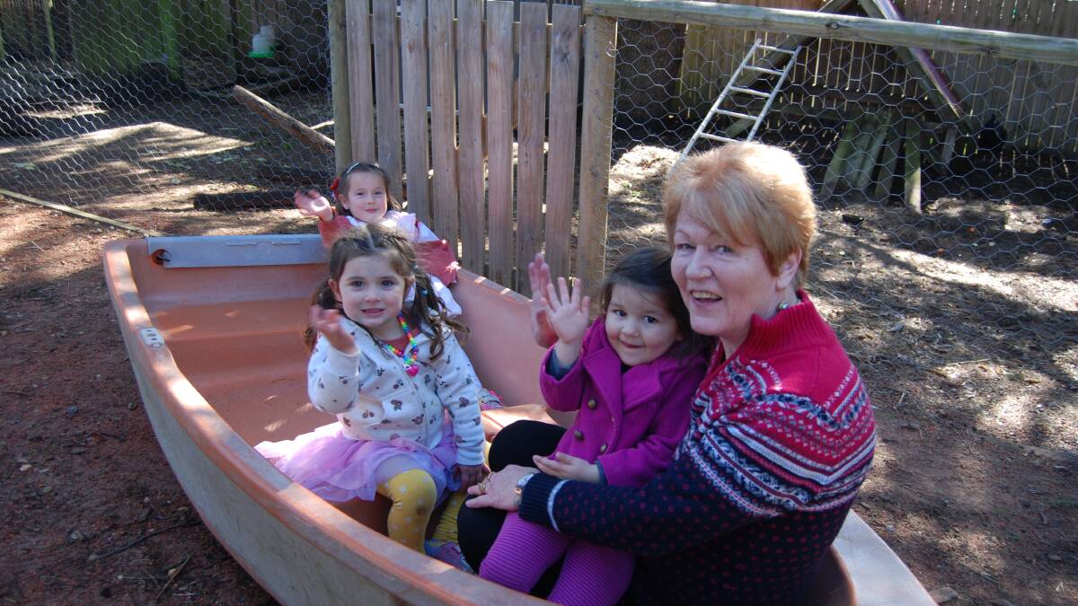 Good listener: Jeanine Goodwin with Ava (at rear), Alia and Vivian in a boat in the back yard of Katoomba Leura Preschool.