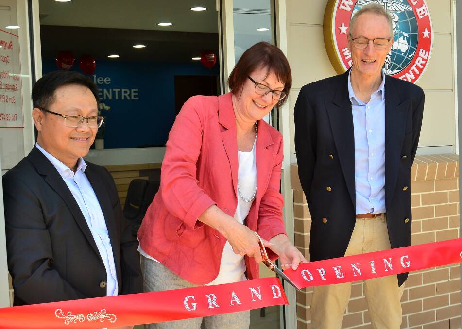 Cutting the ribbon: Susan Templeman, MP, opens the new Winmalee Medical Centre, watched by Dr Van Nguyen and Dr Michael de Vries. 