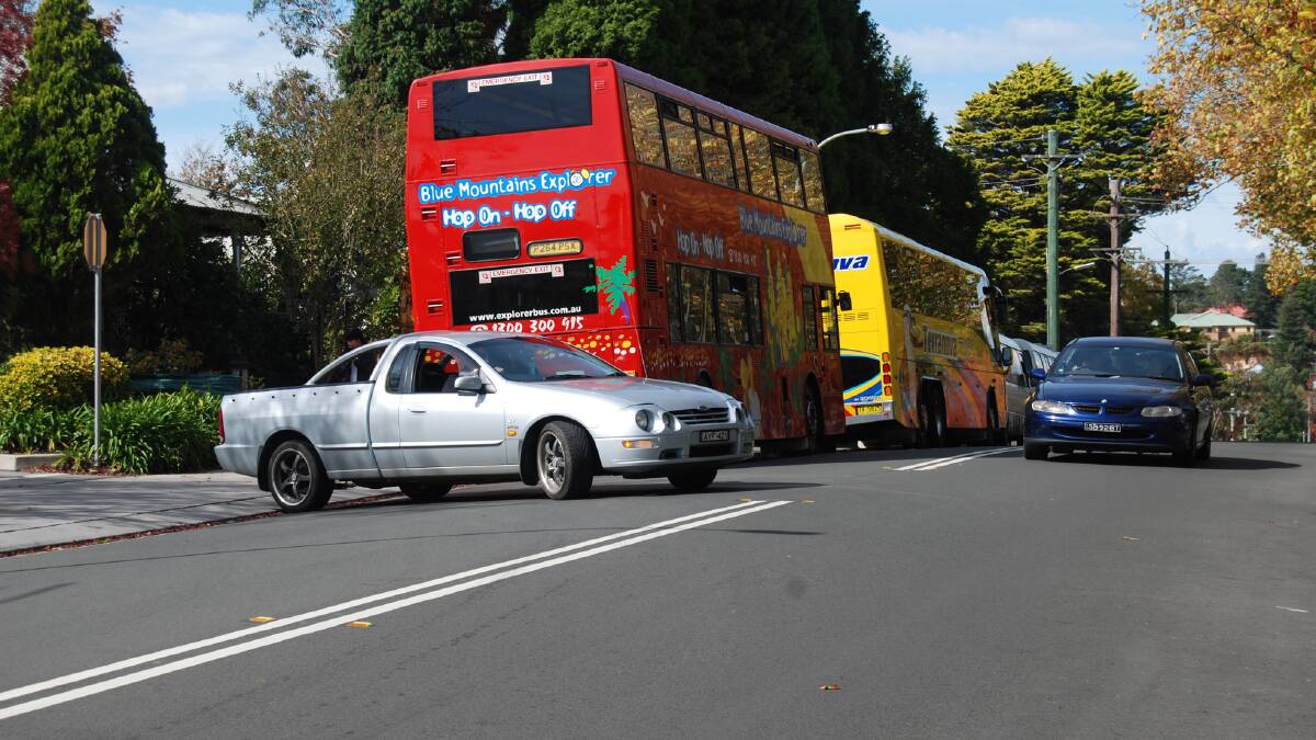A bus blocks the view for the car driver trying to get out of the Woolworths car park on to Megalong Street in Leura. Picture by Jennie Curtin