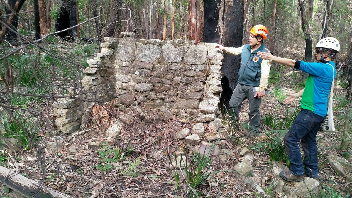 Chris Banffy, NPWS ranger, and Dr Bec Parkes, principal archaeologist with Lantern Heritage at the remains of an old hut.