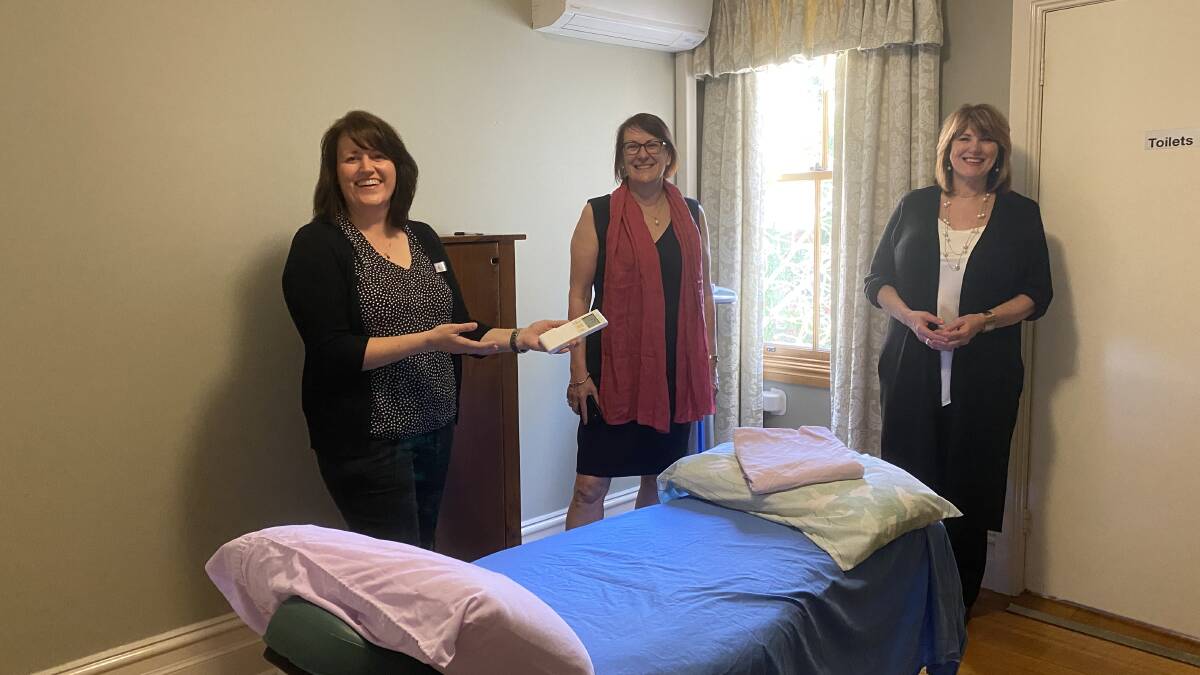 Cancer Wellness Support executive assistant Louise Palmer, Federal Member for Macquarie Susan Templeman and chief executive Bronwen Johnston with a new air-conditioning unit at the Robyn Yates Centre in Leura.