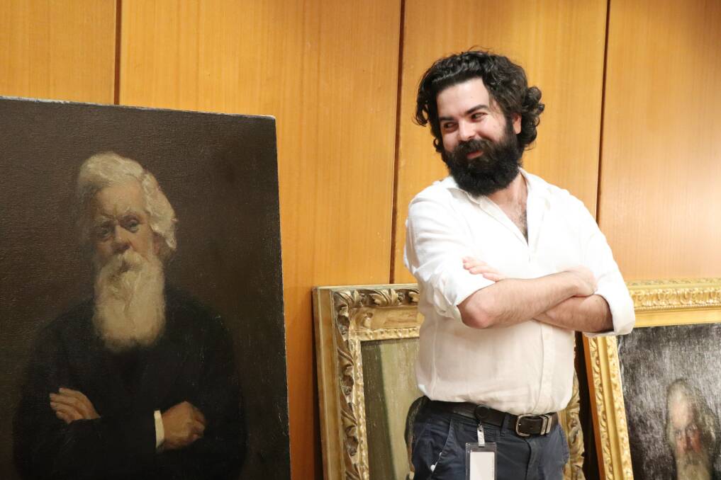 Parliament's collections registrar, Wes Stowe, with the restored portrait of Sir Henry Parkes.