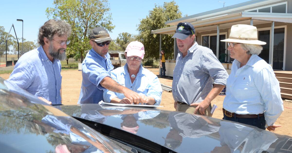 NSW Farmers president James Jackson (left) is shown maps of the proposed rail line through Tondeburine, Gulargambone, by David and Cathy Peart. With them is the Association's Inland Taskforce chair, David Lyons and Dubbo branch chair, Shane Kilby in December, 2018.