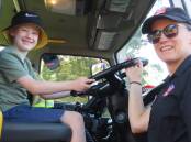 One of the special treats for children at Australia Day in Glenbrook is the appearance of staff and engine from Glenbrook 301 Fire Rescue station. Officer Wendy Hemmons instructs six-year-old Ryan Orr on the engine's operation in 2023. Picture supplied