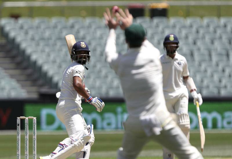 India's Ajinkya Rahane, left, watches as the ball goes to Australia's Peter Handscomb. Photo: AP
