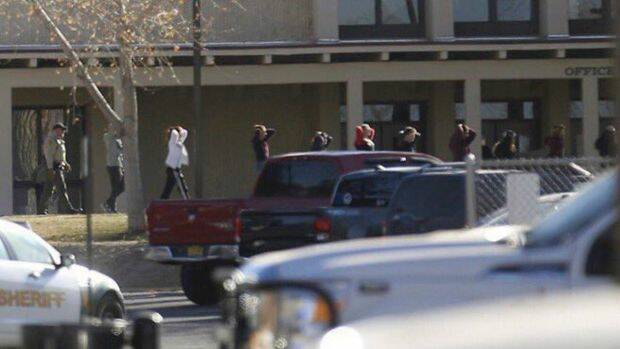 Students are led out of Aztec High School after a shooting in Aztec, New Mexico. Photo: AP